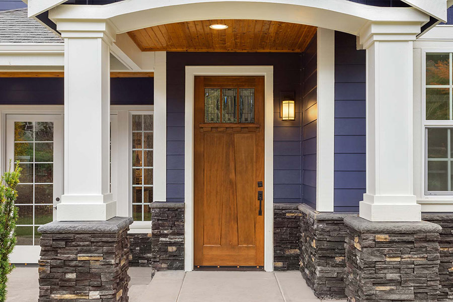wooden-front-door-on-blue-house-taylorsville-ut
