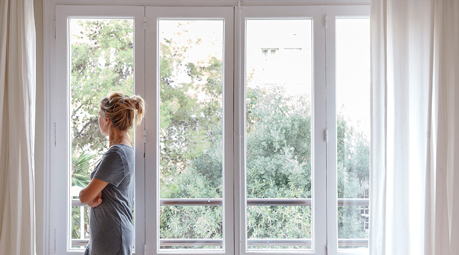 woman standing near windows on nice day taylorsville ut